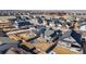 Aerial view of a neighborhood with fenced yards, modern homes, and mountain views at 10976 Lewiston St, Commerce City, CO 80022