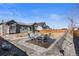 Landscaped backyard featuring stone accents and a firepit ideal for outdoor gatherings and low-maintenance living at 10976 Lewiston St, Commerce City, CO 80022