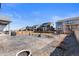 Large backyard featuring a stamped concrete patio, fire pit, and views of the neighborhood at 10976 Lewiston St, Commerce City, CO 80022
