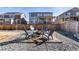 Private fenced backyard with a fire pit and seating area, perfect for enjoying evenings outdoors at 10976 Lewiston St, Commerce City, CO 80022