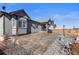 Charming backyard with custom stone patio and low-maintenance landscaping providing year-round appeal at 10976 Lewiston St, Commerce City, CO 80022