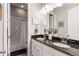 Bathroom featuring double sinks, granite countertops, and a shower-tub combo at 10976 Lewiston St, Commerce City, CO 80022