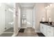 Bright bathroom featuring modern fixtures, a glass-enclosed shower, and wood look flooring at 10976 Lewiston St, Commerce City, CO 80022