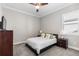 Comfortable bedroom with neutral walls, a ceiling fan, and a bright window at 10976 Lewiston St, Commerce City, CO 80022