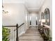 Spacious entryway featuring wood-look flooring, neutral walls, and a decorative console table at 10976 Lewiston St, Commerce City, CO 80022