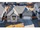 Well maintained single Gathering home showcasing a two-car garage, stone accents and neutral paint at 10976 Lewiston St, Commerce City, CO 80022