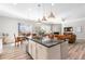 Open-concept kitchen features an island, stainless steel appliances, and blends into the living and dining area at 10976 Lewiston St, Commerce City, CO 80022