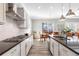 Gourmet kitchen with gas cooktop, granite counters, and a tile backsplash, flowing into a dining area at 10976 Lewiston St, Commerce City, CO 80022