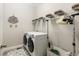 Well-organized laundry room with modern washer and dryer, and ample storage at 10976 Lewiston St, Commerce City, CO 80022