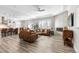 Open concept living area featuring hardwood flooring, neutral paint, and lots of natural light at 10976 Lewiston St, Commerce City, CO 80022