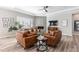 Cozy living room with a corner fireplace, a ceiling fan, and ample seating at 10976 Lewiston St, Commerce City, CO 80022