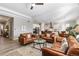 Open-concept living room showcasing the kitchen and dining areas, with a leather seating arrangement at 10976 Lewiston St, Commerce City, CO 80022