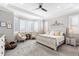 Serene primary bedroom with a tray ceiling, plantation shutters, and neutral decor at 10976 Lewiston St, Commerce City, CO 80022