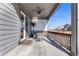 Back patio featuring an outdoor table set, ceiling fan, and views of the neighborhood at 10976 Lewiston St, Commerce City, CO 80022