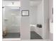 Stylish shower with glass enclosure, gray tiled flooring, and a built-in bench at 10976 Lewiston St, Commerce City, CO 80022