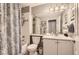 Standard bathroom with a shower-tub combo and white vanity, creating a clean and efficient space at 601 Clarendon Loop, Castle Pines, CO 80108