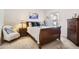 Cozy bedroom features a window, comfortable chair, and dresser, creating a relaxing and inviting atmosphere at 601 Clarendon Loop, Castle Pines, CO 80108