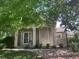 Charming single-story home featuring a welcoming front porch, stone accents, and mature trees at 601 Clarendon Loop, Castle Pines, CO 80108