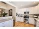 Charming kitchen features white cabinets, stainless steel appliances, and an open layout perfect for entertaining at 601 Clarendon Loop, Castle Pines, CO 80108