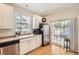 Bright eat-in kitchen boasts stainless steel appliances, white cabinetry, and access to an outdoor patio at 601 Clarendon Loop, Castle Pines, CO 80108