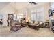 Bright and airy living room with vaulted ceilings, fireplace, comfortable seating, and neutral decor at 601 Clarendon Loop, Castle Pines, CO 80108