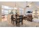 Open-concept living room with dining area, fireplace, and soaring ceilings offers ample natural light and a seamless flow at 601 Clarendon Loop, Castle Pines, CO 80108