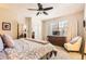 Cozy main bedroom filled with natural light and equipped with a ceiling fan, a closet, and a dresser at 601 Clarendon Loop, Castle Pines, CO 80108