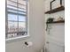 Cozy bathroom featuring a decorated window, floating shelves, and a toilet at 7912 S Depew St # A, Littleton, CO 80128
