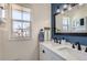 Bright bathroom with double sink vanity, stylish lighting, and neutral color palette at 7912 S Depew St # A, Littleton, CO 80128