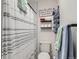 Neat bathroom with shower/tub and decorative storage shelves at 7912 S Depew St # A, Littleton, CO 80128