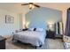Cozy bedroom featuring a light blue accent wall, carpet floors, and large bed at 7912 S Depew St # A, Littleton, CO 80128