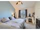 Comfortable bedroom showcasing a light blue accent wall and window with natural light at 7912 S Depew St # A, Littleton, CO 80128