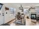 Stylish dining room featuring hardwood floors, bright windows, and modern lighting at 7912 S Depew St # A, Littleton, CO 80128