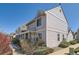 Charming multi-level home featuring tidy landscaping, a columned front porch, and muted siding at 7912 S Depew St # A, Littleton, CO 80128