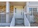 Inviting front entrance with a cozy porch, featuring stone accents and a well-maintained entryway at 7912 S Depew St # A, Littleton, CO 80128