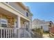 Inviting home exterior showcasing stone accents, a cozy front porch, and a well-manicured garden at 7912 S Depew St # A, Littleton, CO 80128