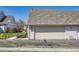 A well-maintained two-car garage exterior with a light-colored door, set in a neatly kept neighborhood on a sunny day at 7912 S Depew St # A, Littleton, CO 80128