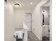 Bright hallway featuring gray carpet, white doors, and stairway at 7912 S Depew St # A, Littleton, CO 80128
