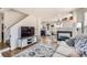 Comfortable living space showcasing an entertainment center, a fireplace, and an open floor plan at 7912 S Depew St # A, Littleton, CO 80128