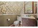 Stylish powder room with decorative wallpaper and wood vanity at 26175 E Fair Pl, Centennial, CO 80016