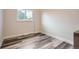 Cozy bedroom with wood-look floors and natural light, ready for personalization at 3654 Fairfax St, Denver, CO 80207