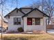 Charming home featuring a red front door, white painted brick, and a cozy front porch at 1540 Clermont St, Denver, CO 80220