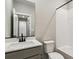 Well-lit bathroom featuring a sleek vanity, quartz countertops, and tub-shower combo at 9376 Yampa Ct, Commerce City, CO 80022
