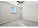 Cozy bedroom with soft carpet, a window for natural light, and a ceiling fan at 9376 Yampa Ct, Commerce City, CO 80022