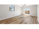 Bright bedroom with wood flooring, slider door, and window for natural light and backyard access at 9376 Yampa Ct, Commerce City, CO 80022