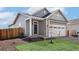 Charming home featuring a well-manicured lawn and a two-car garage, perfect for suburban living at 9376 Yampa Ct, Commerce City, CO 80022