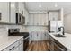Modern kitchen with stainless steel appliances, gray cabinets, tile backsplash, and quartz countertops at 9376 Yampa Ct, Commerce City, CO 80022
