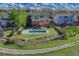 Aerial view of a home with a private backyard, in-ground pool, deck, and manicured lawn in a residential neighborhood at 18885 E Union Dr, Aurora, CO 80015