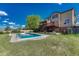Inviting backyard features a sparkling pool, wooden deck, and lush green lawn perfect for outdoor relaxation and entertainment at 18885 E Union Dr, Aurora, CO 80015