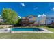 Backyard view showcasing an in-ground pool, spacious grassy area, and a raised deck for outdoor living and entertaining at 18885 E Union Dr, Aurora, CO 80015